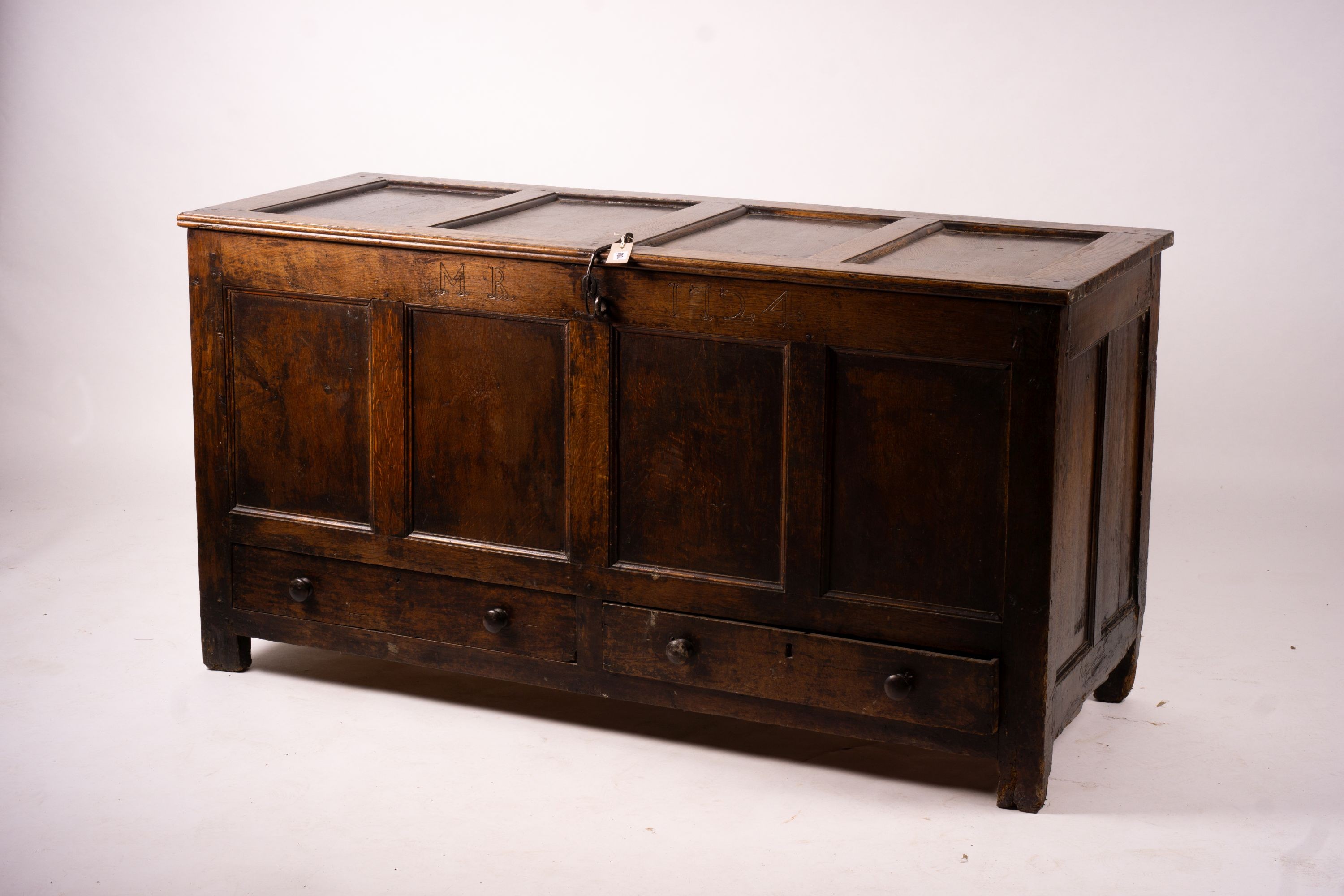 An 18th century panelled oak mule chest, length 161cm, depth 61cm, height 84cm